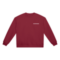 Compass Crewneck Sweatshirt. A red crewneck sweatshirt with a The infinity style Studio compass logo.  Keep you looking stylish, warm and comfy on your confidence recovery journey. red  crewneck front view