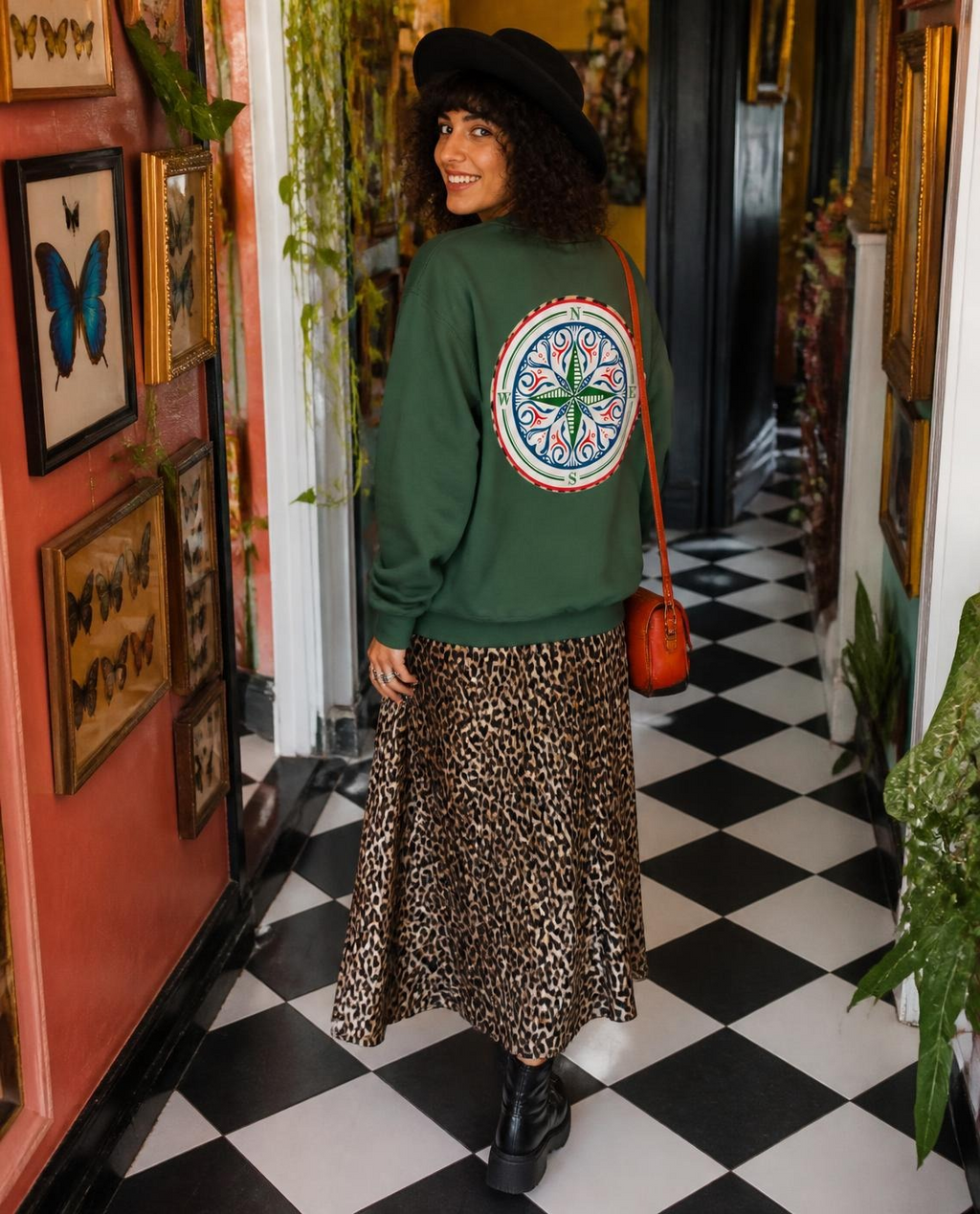 Compass Crewneck Sweatshirt. A green  crewneck sweatshirt with a The infinity style Studio compass logo.  Keep you looking stylish, warm and comfy on your confidence recovery journey. green crewneck back view model